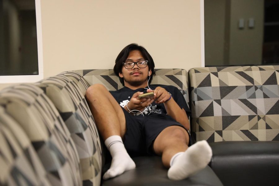 Roi slouching in the common area of the dorms.