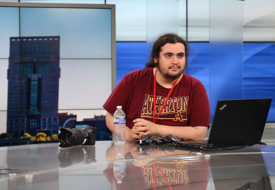 Vince Porco sits at the anchor desk ar WDRBs broadcasting room. 